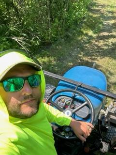 Eddie Bosas Jr. on a tractor during a habitat land management project.