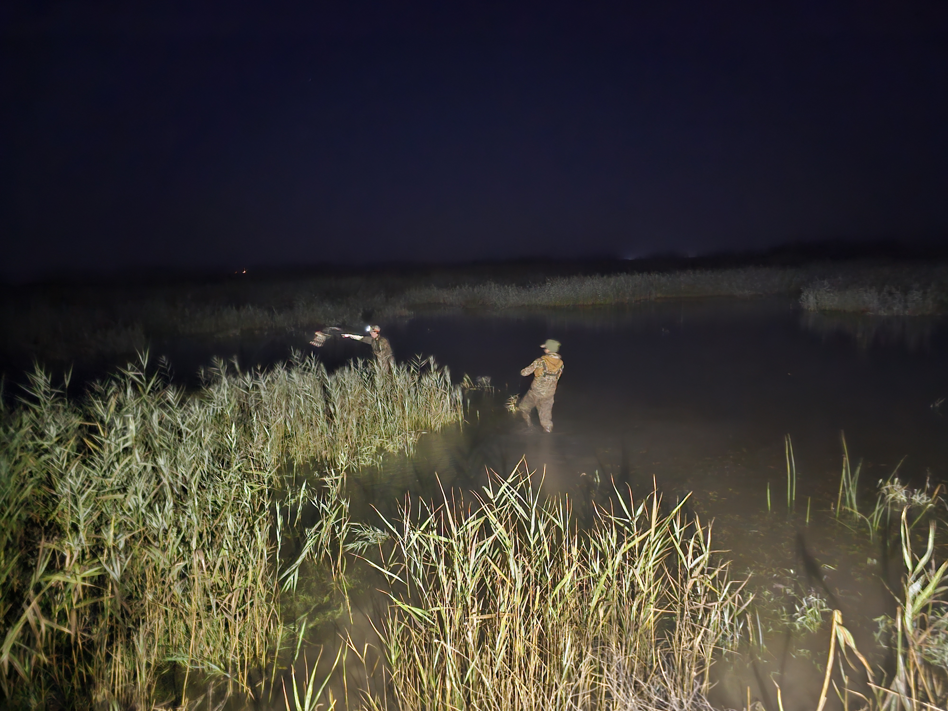 Two duck hunters place their decoys in the pre-dawn light at Fish Point