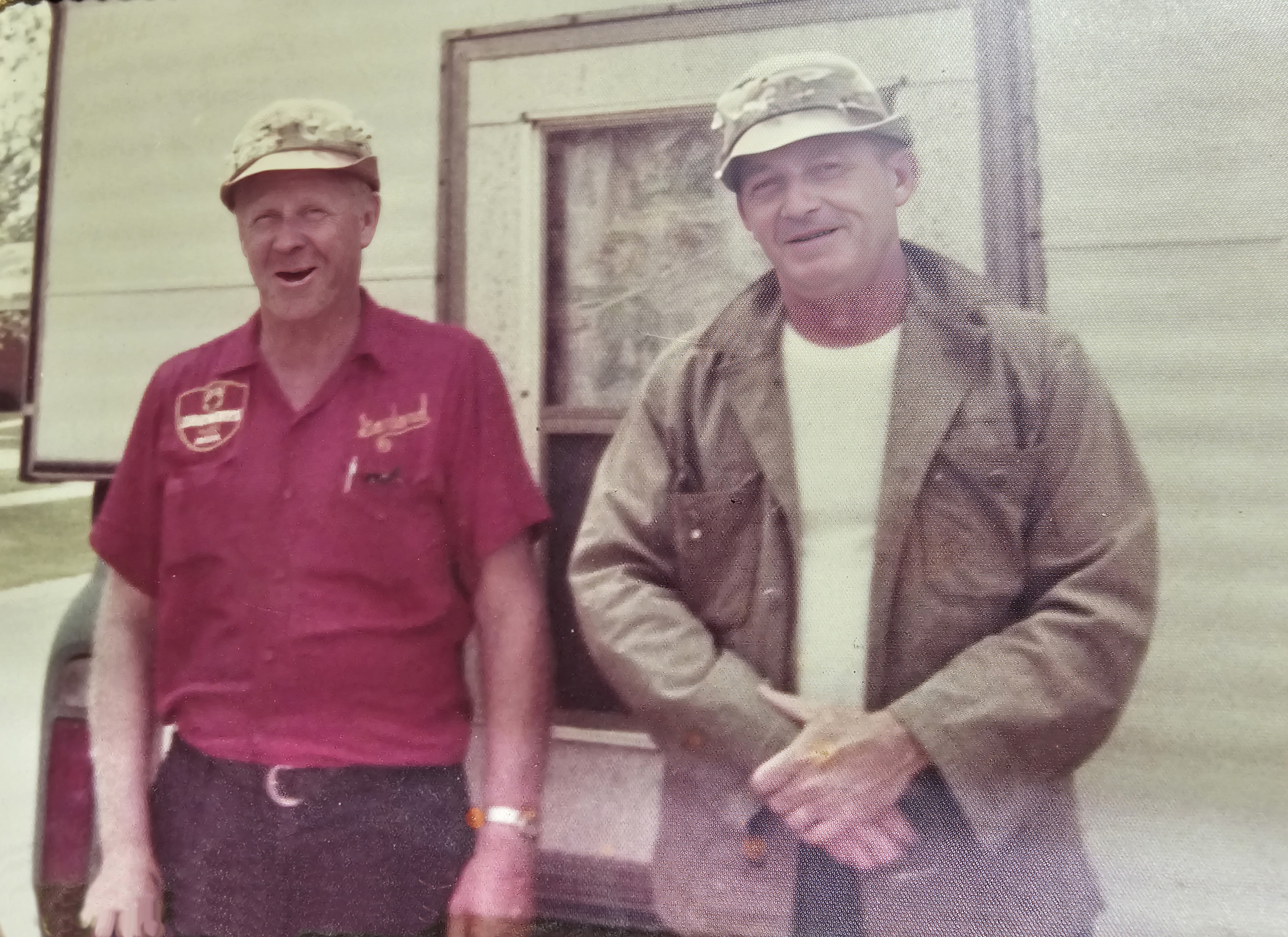 Two men standing behind a camper mounted on a pickup truck, just before leaving to fish for salmon
