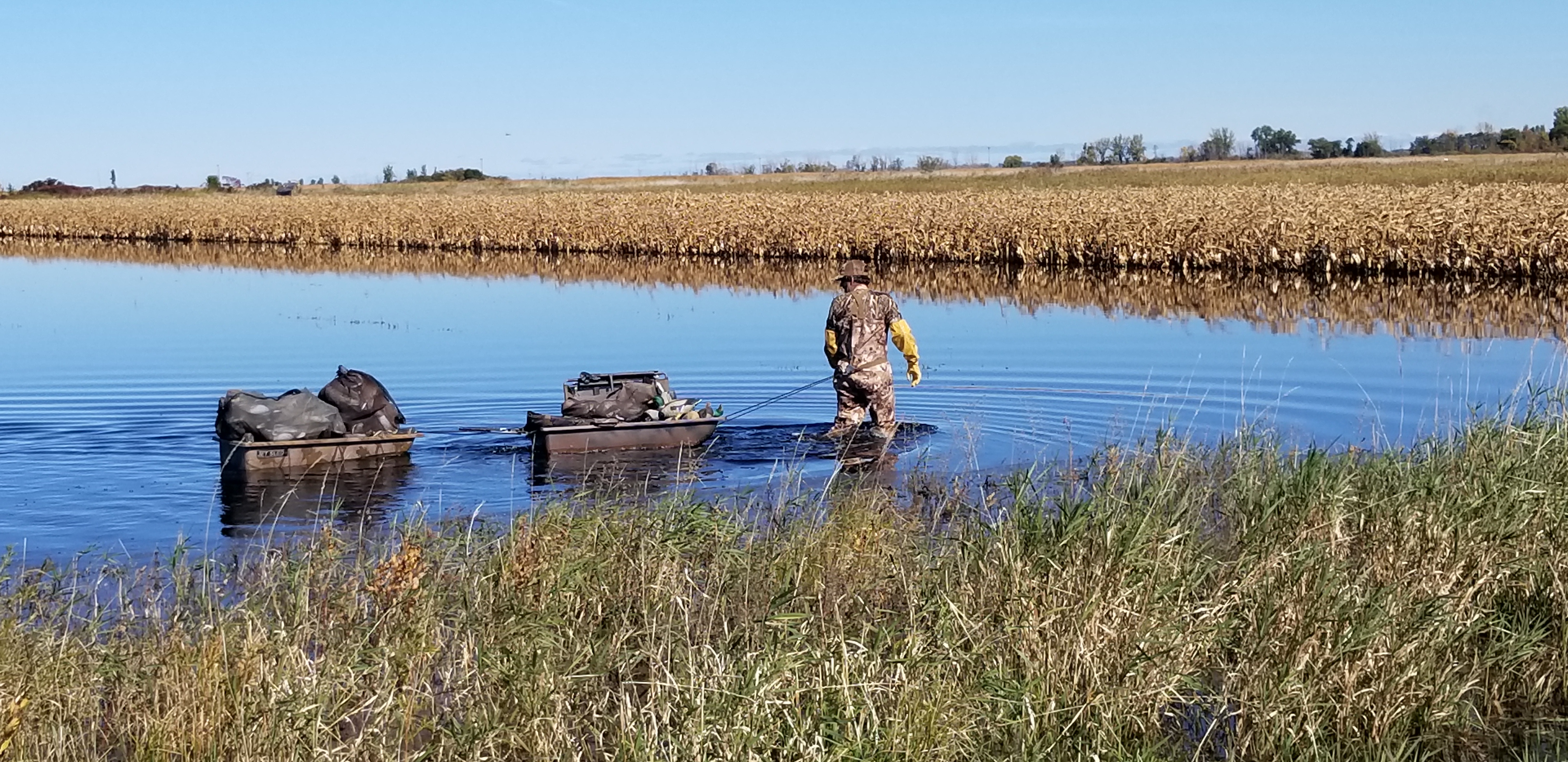 A hunter pulls duck decoys in two jet sleds at a Michigan Managed Waterfowl Area