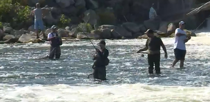 A group of fishermen near one of Michigan's dams, trying to catch salmon